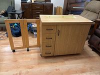 Side view showing extendable drop leaf, drawers, and caster wheels
