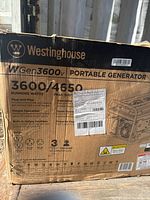 Cardboard box labeled Westinghouse WGen3600v portable generator with running watts 3600 and peak watts 4650