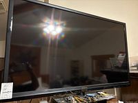Front view of Westinghouse flat screen TV showing entire screen and black frame with some surface reflections and dust visible.