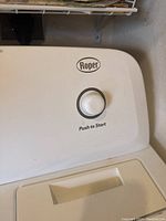 Close-up of the Roper logo and push-to-start button on the dryer's control panel.