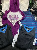 Lot showing 2 boys' jerseys, 2 girls' tank tops, and 1 girls' hoodie with visible size tags.