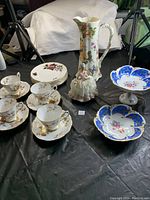Full lot showing all items including plates, cups, candy dishes, jug and figurine