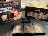 Photo showing China Glaze The Cat Eye nail polish set and O.P.I Love O.P.I nail care kit along with three Elizabeth Arden single eyeshadow boxes and one duo eyeshadow box.