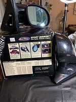 Photo showing the Road Vision Sport Mirror packaging and one mirror unit placed on the box, highlighting product information on box.