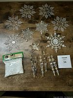 Clear snowflake ornaments, clear icicle ornaments, clear star ornament, and a bag of small clear beads.
