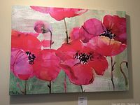 Full view of the canvas painting showing bright pink flowers on green background with signature in bottom left corner.