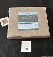 Packaged twin size duvet cover set in soft brown with luxury weave by Sunset brand, showing front label and packaging.