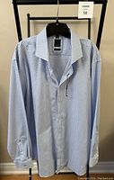 Front view of brand new men's long sleeve shirt in blue and white checkered pattern on hanger.