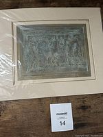 Etched artwork with human figures and abstract elements, mounted with cream mat board.