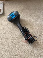 Top view of handheld back massager showing dual rounded massage nodes with blue accent.