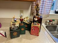 Full view of six Boyds Bears collectible figurines on countertop with original boxes.