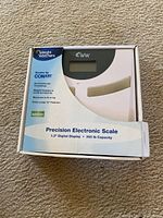 Photo of Weight Watchers Precision Electronic Scale boxed showing front of box with scale image and info