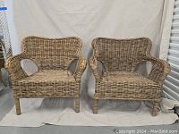 Full frontal view of both wicker chairs showing overall condition and shape