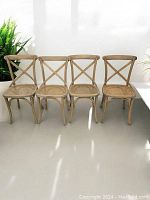 Four chairs lined up side by side against white backdrop showing full set and finish
