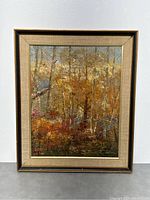 Full view of framed oil painting showing the autumn forest scene and the overall condition of the frame.