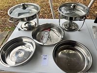 Overview of the catering set showing 2 chafing dishes with glass lids and stands, 2 oval serving trays, and 1 round tray with utensils