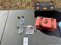 Full view of the jewelry pieces together with the two jewelry boxes on a table outdoors.