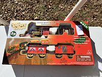 Box showing Jumbo Santa's Express train set with 20 pieces, including locomotive and cars in packaging.
