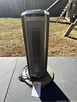 Front view of Lasko tower space heater showing the grille and cord.