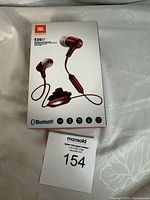 Front of the boxed JBL E25BT wireless in-ear headphones with product image and Bluetooth logo.