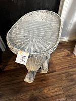 Top-down view of white wicker elephant shaped table showing the woven oval surface and trunk detail.