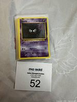 Stack of used Pokémon cards with Gastly card visible on top