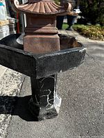 Close-up photo of the fountain basin and pagoda top showing material texture and wear.