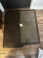 Photo showing both anti-fatigue mats side by side on hardwood floor, displaying the different surface patterns and condition.