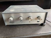 Front view of Armaco T420 solid-state public address amplifier showing four control knobs and power cord.