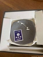 Square blue-gray ceramic plate with white delicate cherry blossom branch design, box included.