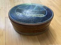 Top view of the ceramic dish with lid on, showing the glaze pattern and colors.