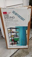 Boxed steel shelving unit by Sears, labeled 'Heavyweight Steel Shelving' showing product image and dimensions.