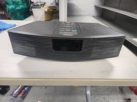 Front view of black Bose Wave Radio showing speaker grill and display screen.