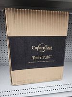 Closed cardboard box labeled as Copernicus Tech Tub2 educational product for device storage.