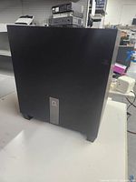 Full view of black Definitive Technology Studio Micro subwoofer showing front and sides