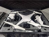 Open view of drone and accessories in foam-lined case