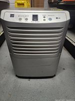 Front view of LG EnergyStar Dehumidifier showing the digital control panel with buttons and display, unit's vented grille, and overall condition.