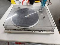 Full view of the Technics SL-10 turntable with closed dust cover showing the platter and tonearm.