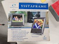 Box showing Vistaframe by Vialta digital picture frame details including 6.8" TFT LCD screen, memory card compatibility, and motion sensor-activated display.