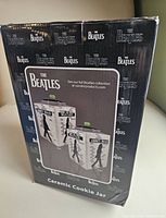 Packaging box showing front and back images of the ceramic cookie jar with The Beatles Abbey Road design on it.