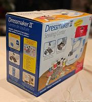 Box of Dressmaker II Sewing Center showing images of included sewing machine and accessories with text highlighting compact and practical features.