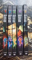 Spine view of The Six Million Dollar Man DVD box sets for seasons 1 through 5.