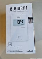 Photo of the Nuheat Element floor heating thermostat in its original packaging showing the front of the box and thermostat display.
