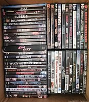Top view of three stacks of DVDs showing spine titles featuring mostly action and adventure films.