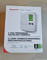 Photo of Honeywell thermostat retail box showing product image and product details