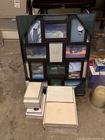 Black multi-photo frame showing nine photos of landscapes and scenery, surrounded by white individual frame boxes stacked beside it.