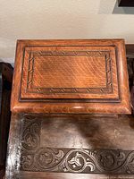 Closed wooden box with decorative inlay on top showing the poker chip holder box lid design.