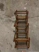 Wooden wine rack shown from top perspective folded in compact position.