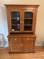 Front view of full cabinet and hutch on floor showing overall condition and finishes