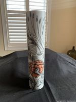 Front view of tall cylindrical Rosenthal vase with floral design showing coral flower accents.